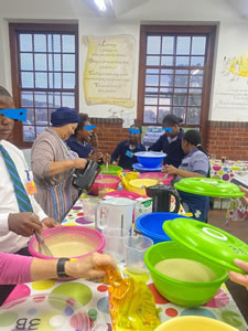 Marlene making e'Pap with some helpers